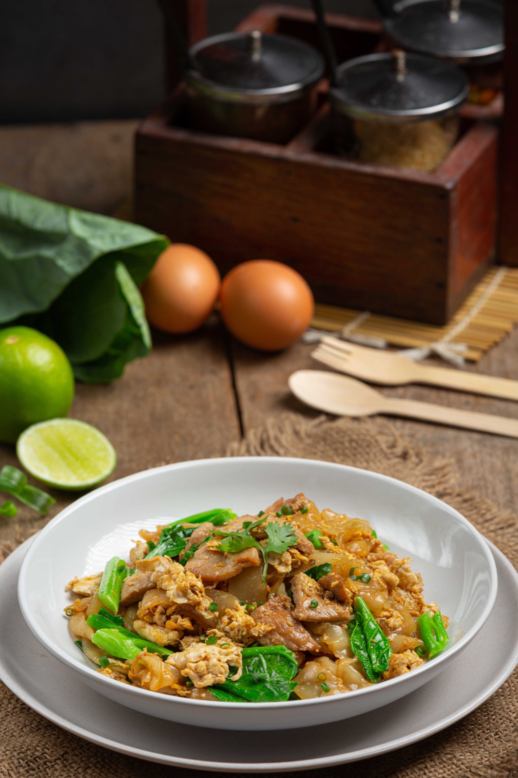 Chicken Pad See Ew with wide noodles, egg and green vegetables