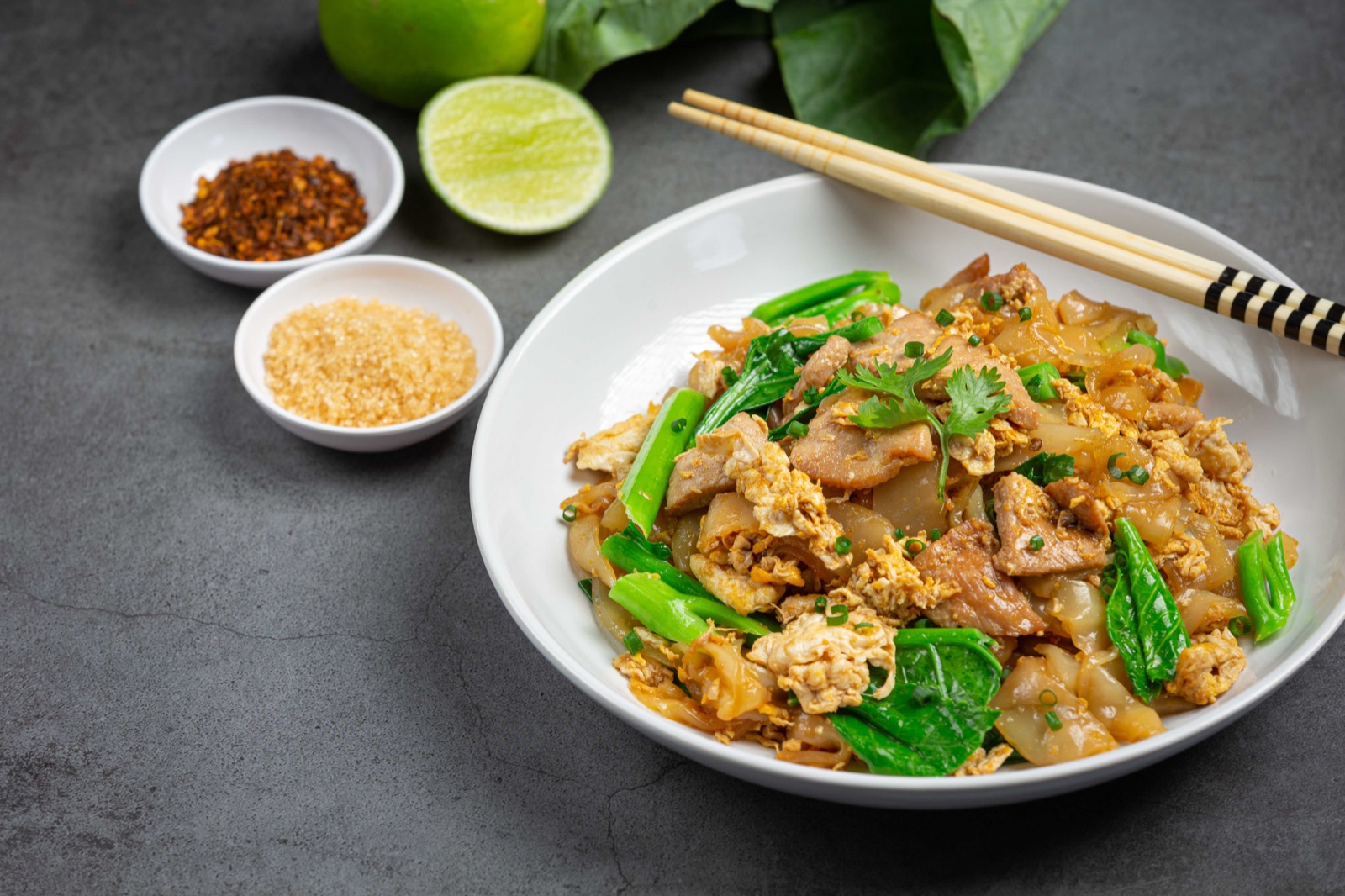Chicken Pad See Ew with wide rice noodles, egg and Chinese broccoli