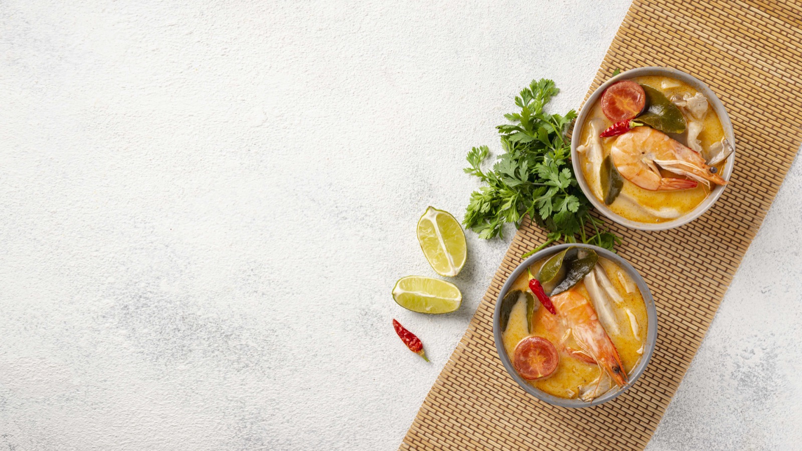 Tom Yum shrimp soup with mushrooms, tomatoes, lime and herbs