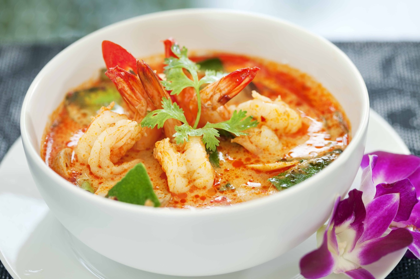 Tom Yum shrimp soup with mushrooms, tomatoes and Thai herbs
